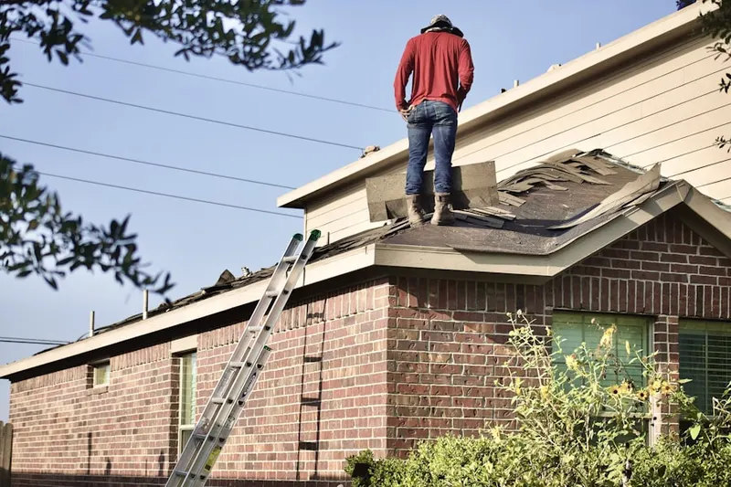 Professional roofer working on a residential roof in Mt. Washington